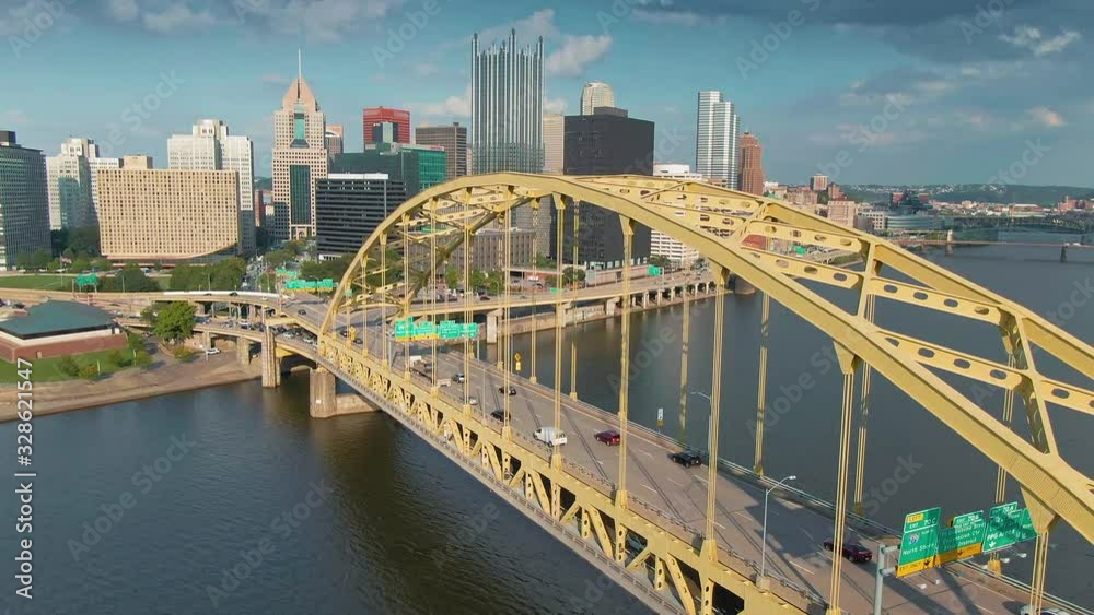 Aerial: Rush hour traffic on the Fort Pitt Bridge that crosses the Monongahela River. In the background is downtown Pittsburgh skyline. Pennsylvania, USA