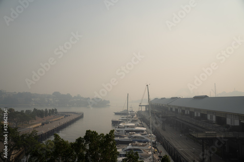 Sydney, NSW - November 21th 2019: The Sydney skyline behind Pyrmont is engulfed in smoke from various bushfires in NSW. © Nick