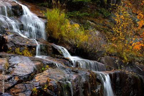 Small water falls by highway 155 in Quebec province during autumn time
