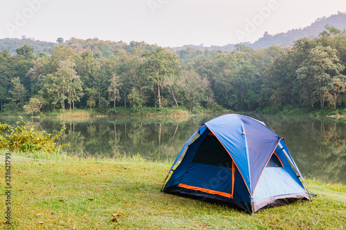 Camping tent by a lake with mist at sunrise Jedkod-Pongkonsao Natural Study in Saraburi Thailand