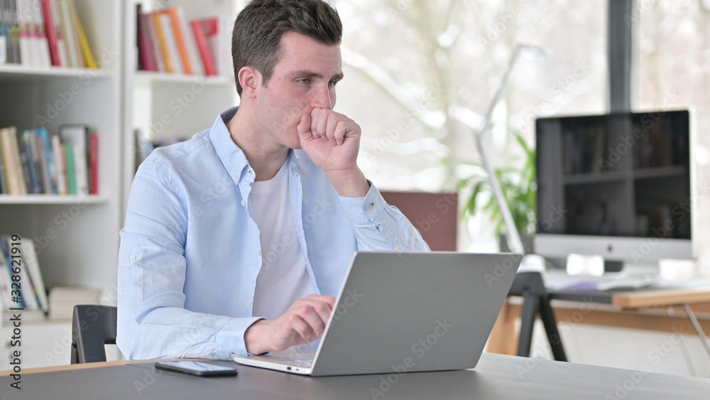Young Man having Coughing Working on Laptop Young Man having Coughing Working on Laptop