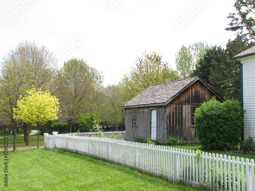 house exterior with white picket fence in Spring. Scarbourgh, Ontario, Canada.