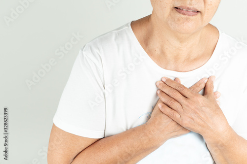 Old woman heart attack holding breast on white background