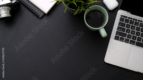 Top view of workspace with laptop, coffee cup, notebooks and copy space