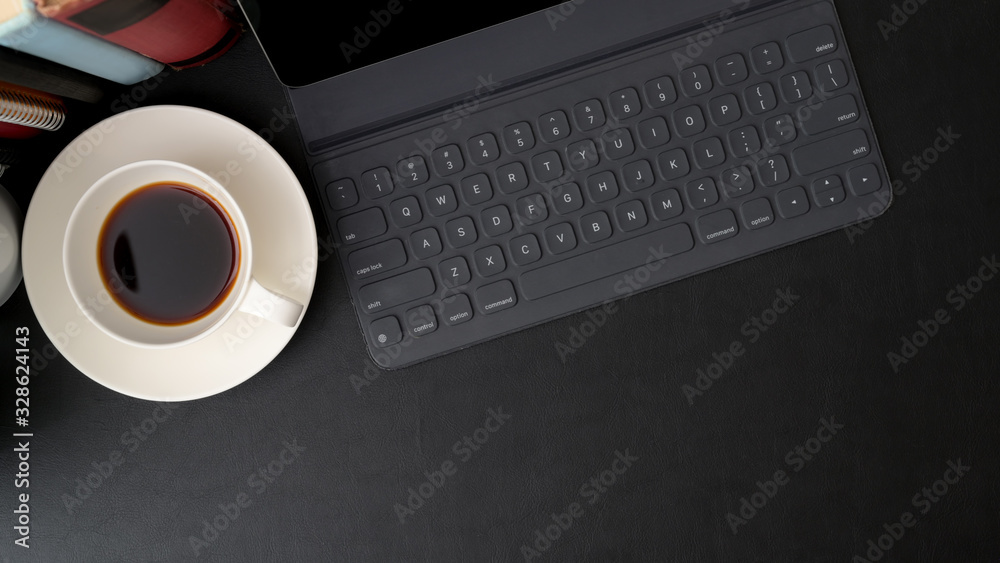 Top view of trendy workspace with digital tablet, coffee cup, books and copy space Top view of trendy workspace with digital tablet, coffee cup, books and copy space