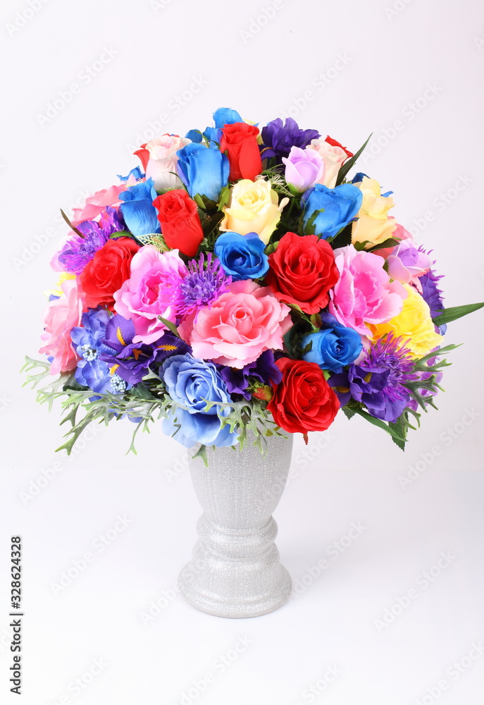 Fototapeta premium Colorful flower arrangement centerpiece in white ceramic vase