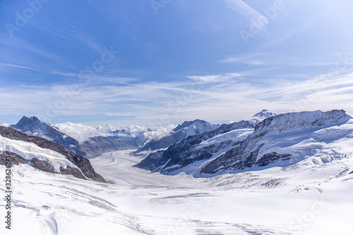 Great Aletsch glacier and Bernese Alps and jungfrau snow mountain peak  with blue sky background view from Jungfraujoch top of Europe, Switzerland © Prathaan