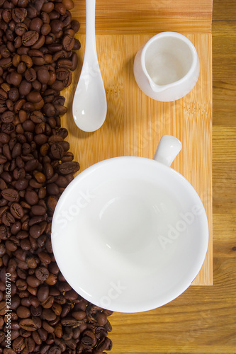 Coffee beans and a cup with milk jug