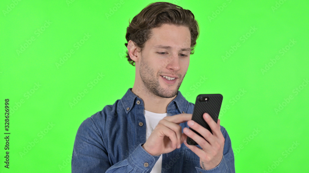 Portrait of Young Man using Smartphone on Green Chroma Key Portrait of Young Man using Smartphone on Green Chroma Key