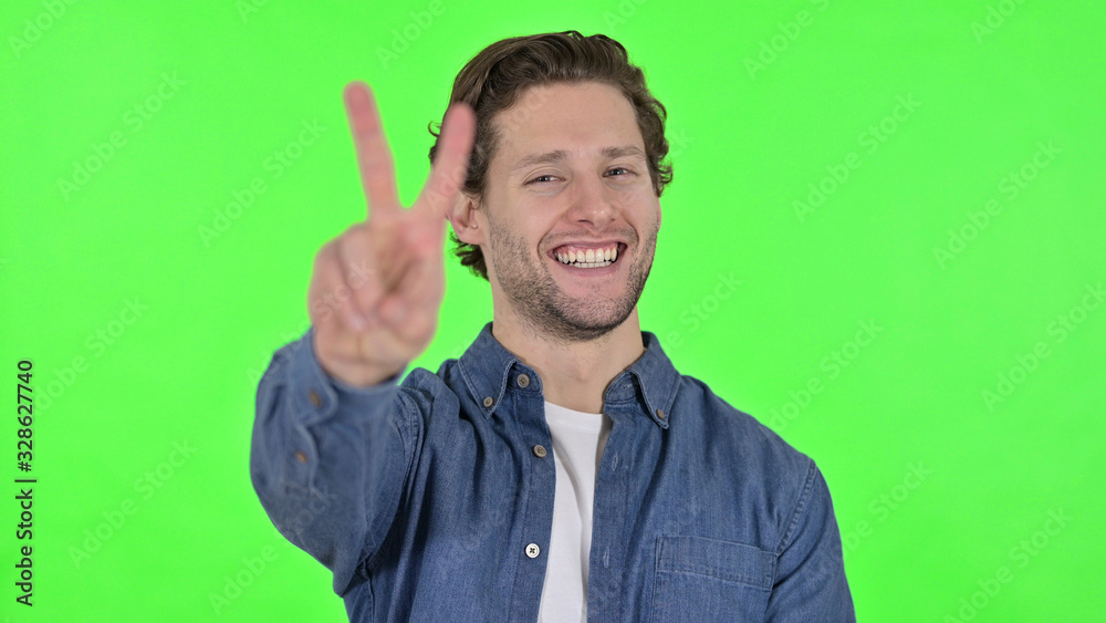 Victory Sign by Successful Young Man on Green Chroma Key Victory Sign by Successful Young Man on Green Chroma Key