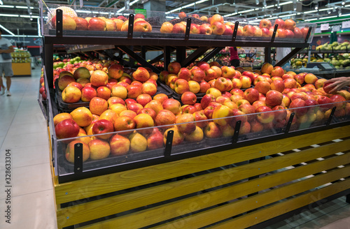 Fresh healthy fruits on shelves in supermarket