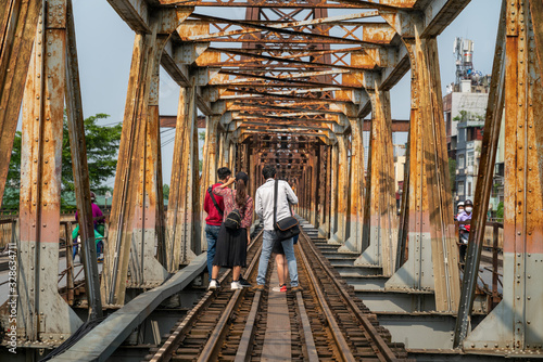 Railways on Long Bien ancient metal bridge with people taking photo on railways photo