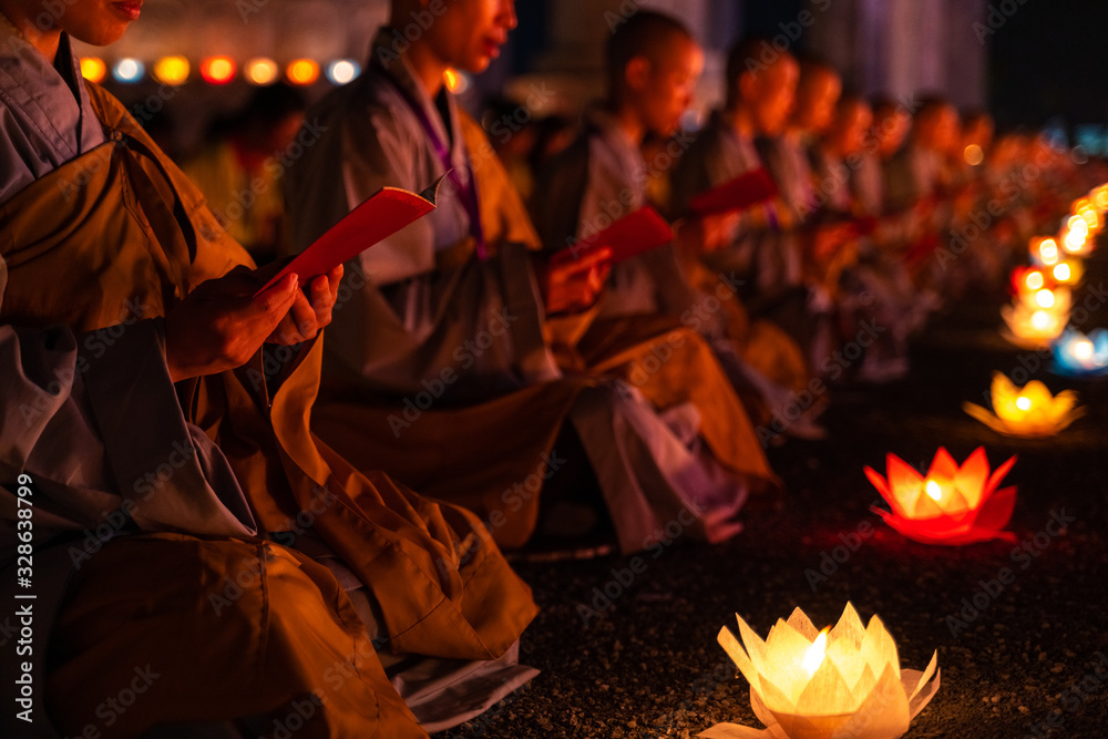 Monks praying at night on Vesak day for celebrating Buddha's birthday in Eastern culture