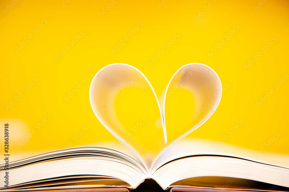 Close up image of a book in heart shape on the table at library of lifestyle love to read and february valentine day concepts. Close up image of a book in heart shape on the table at library of lifestyle love to read and february valentine day concepts.