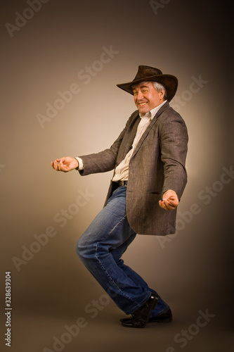 A respectable grey-haired Latino male in a hat.