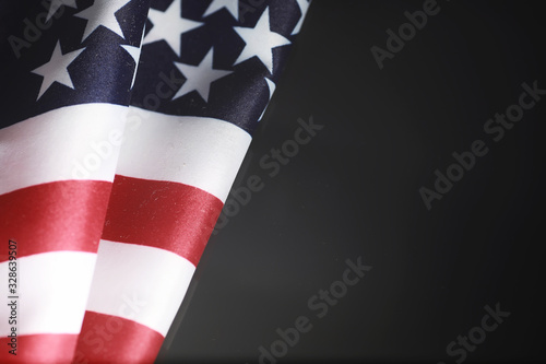 American flag on a mirror background. Symbol of the United States of America. Star-striped flag on a black background.