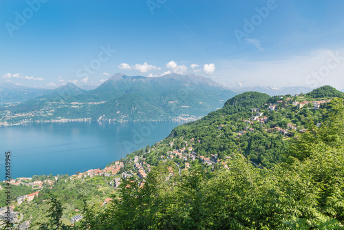 Large European lake seen from above. Lake Como  Italy with the village of Varenna at the bottom and the village of Perledo on the hill. Panorama from the road to Esino Lario