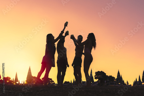 Sticker Friends toasting beers at beach sunset party silhouette enjoying summer vacation
