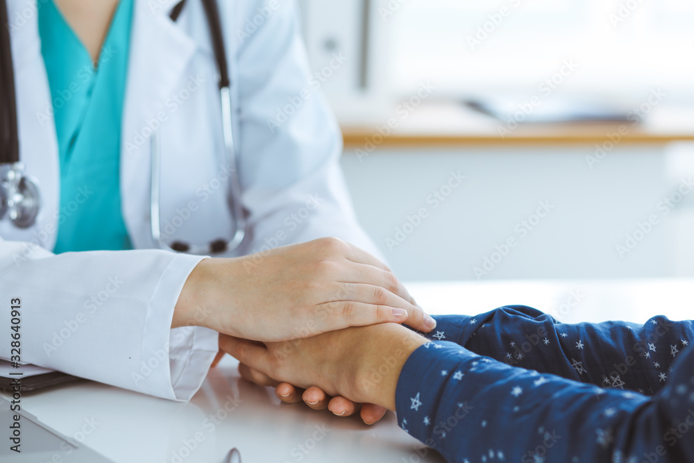 Close-up of doctor reassuring her female patient. Medical ethics and trust concept Close-up of doctor reassuring her female patient. Medical ethics and trust concept