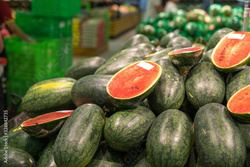 Fresh healthy fruits on shelves in supermarket