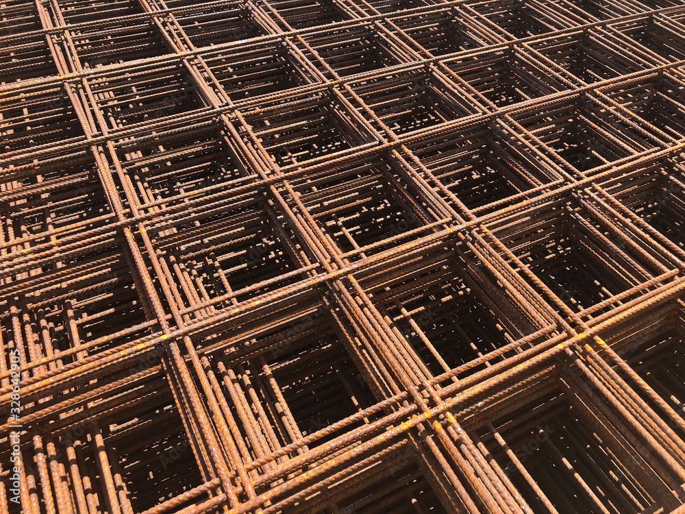 Piled iron reinforcement workpieces. Metal mesh for reinforcement. Iron rusty rectangular structure