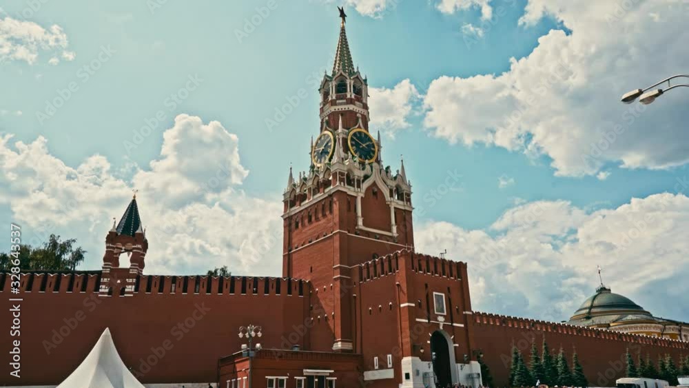 Tilt-up to reveal the imposing Spasskaya Tower (Saviour Tower) on the eastern wall of Moscow's Kremlin against a blue sky backdrop Tilt-up to reveal the imposing Spasskaya Tower (Saviour Tower) on the eastern wall of Moscow's Kremlin against a blue sky backdrop