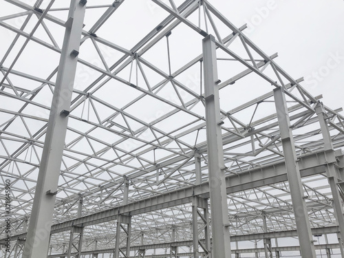 Truss ceiling and metal pillars and girders. Support constructions.