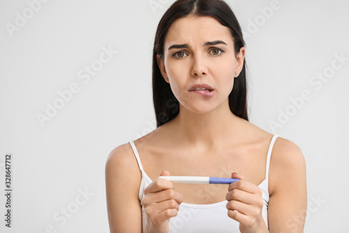 Sad young woman with pregna...