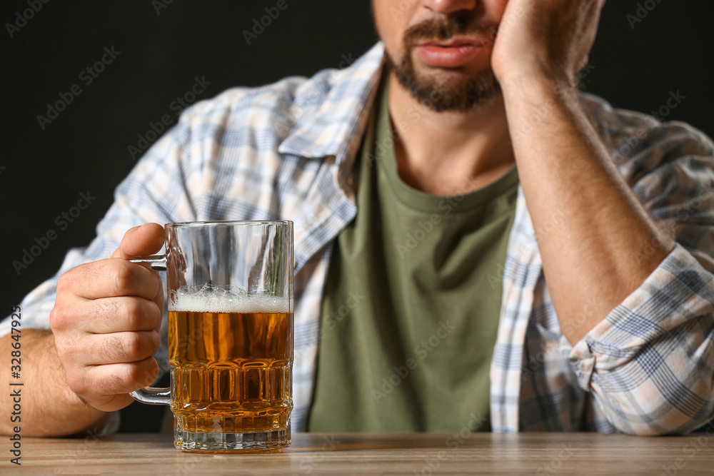 Mature man drinking beer at table Mature man drinking beer at table