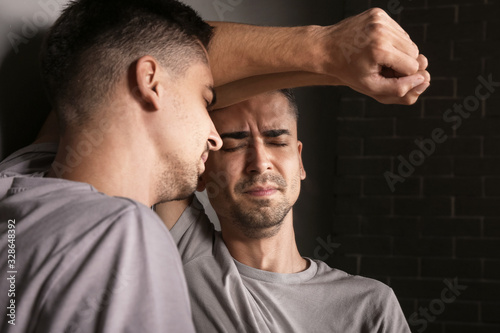 Depressed young man near mirror