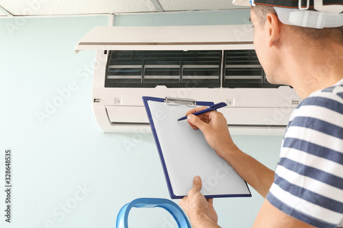 Male technician repairing a...