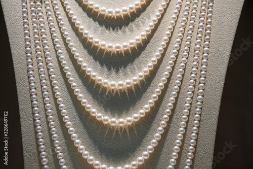Beautiful pearl necklace on mannequin, close up photo