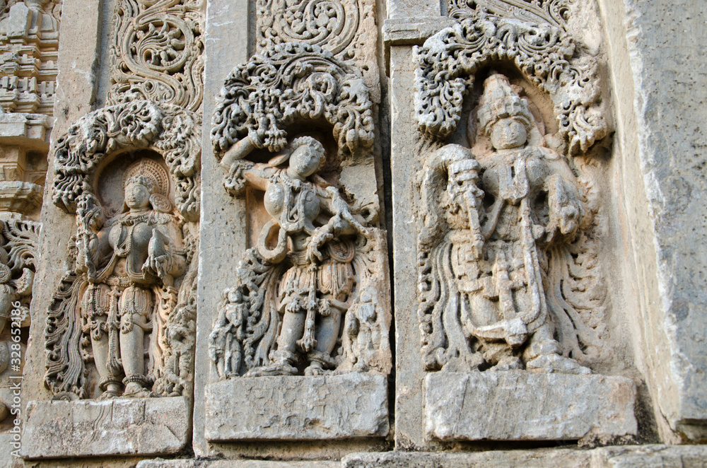 Carved idols on the outer wall of Shantinatha Basadi, near Shravanabelagola, Karnataka, India