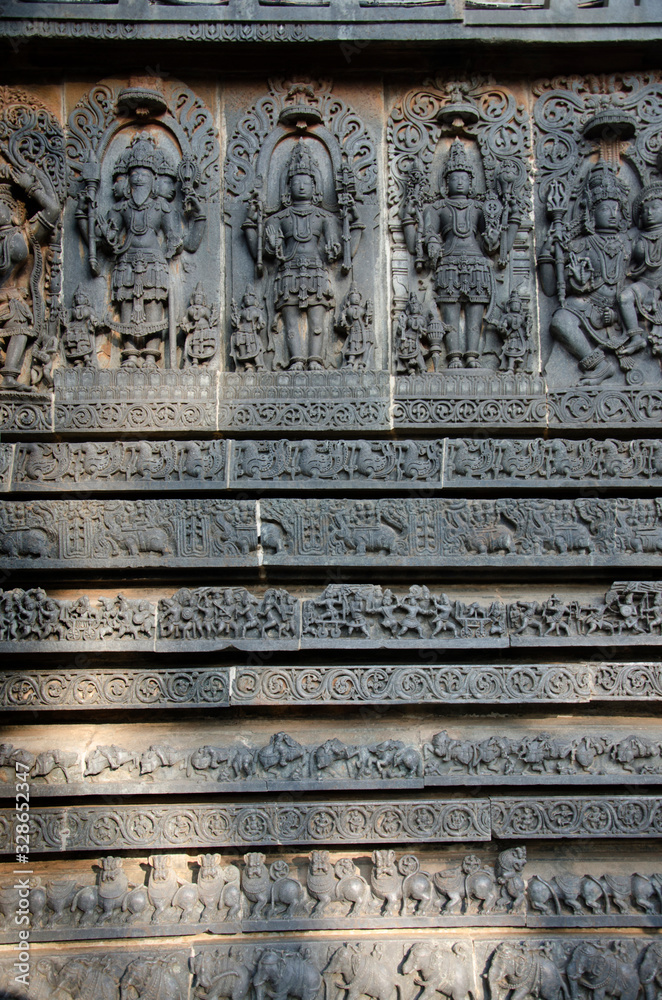 Carved idols on the outer wall of Hoysaleswara temple, is a 12th-century Hindu temple dedicated to lord Shiva, Halebeedu, Karnataka, India