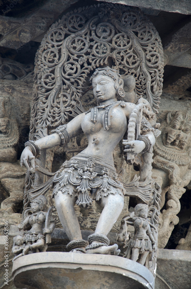 Carved sculptures on the outer wall of the Chennakeshava Temple complex, 12th-century Hindu temple dedicated to lord Vishnu, Belur, Karnataka, India
