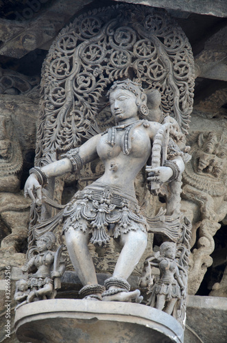 Carved sculptures on the outer wall of the Chennakeshava Temple complex, 12th-century Hindu temple dedicated to lord Vishnu, Belur, Karnataka, India
