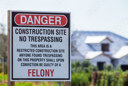 Wallpaper Mural Venice FL December 29, 2019 - A large 'Danger Construction Site' sign is shown with a partially completed house in the background. The sign also states No Trespassing and Felony  Torontodigital.ca