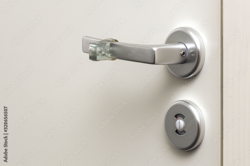 Close up view of lock and handle buffer rubber on white door. Interior design. Beautiful backgrounds. Close up view of lock and handle buffer rubber on white door. Interior design. Beautiful backgrounds.