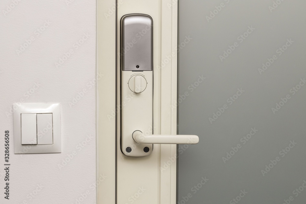 Close up view of an electric combination lock on a white door. Interior design. Beautiful backgrounds. Close up view of an electric combination lock on a white door. Interior design. Beautiful backgrounds.