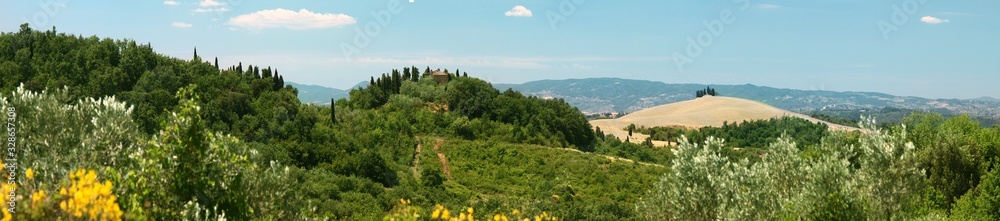 Panoramic summer view of Tuscan landscape. Volterra suburbs. Italy.