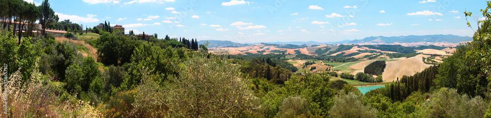 Panoramic summer view of Tuscan landscape. Volterra suburbs. Italy.