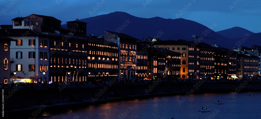 Night illumination of Arno River embankment for San Ranieri Luminaria festival. Pisa. Italy.