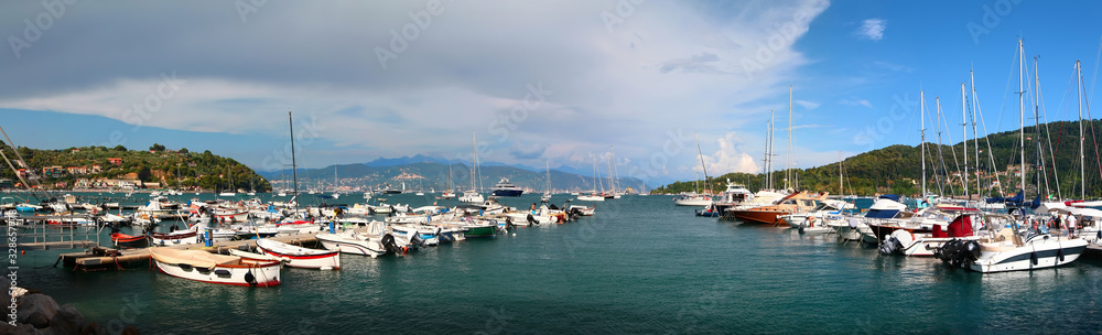 Panoramic sunset view of Italian town with boats moored in the seaport. Portovenere. Ligurian Sea. Italy.