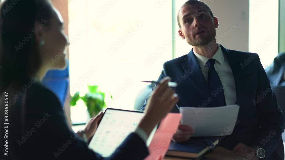 Caucasian male and female office colleagues discussing business information dor collaboration during brainstorming meeting, progressive executive managers communicating indoors