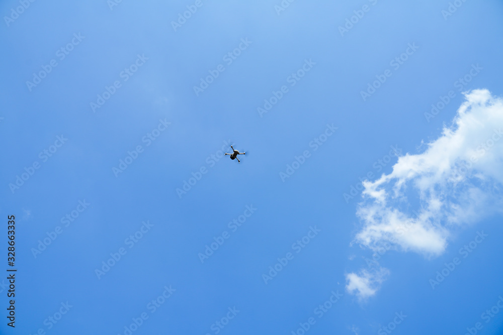Fototapeta premium Drone flying over blue sky, take photo and video