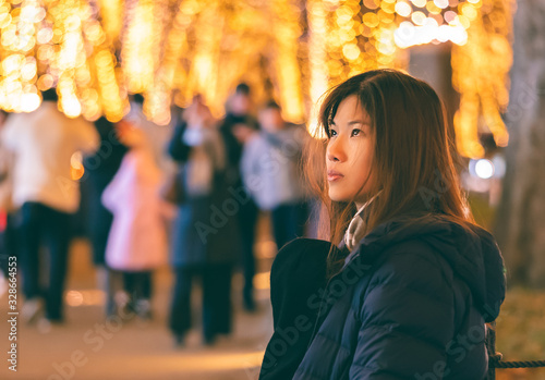 Beautiful Woman portrait in winter clothing at night in The Jozenji christmas light up festival in Sendai, Japan photo