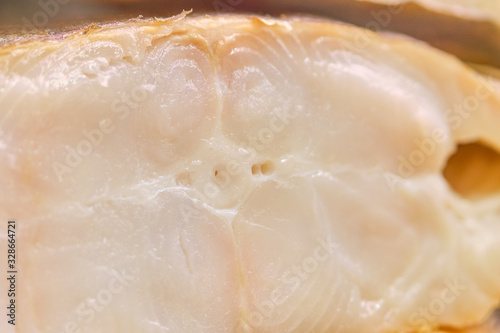 Smoked fish in a cut on a store counter.
