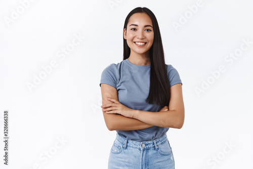 Lively, enthusiastic and determined smiling confident asian girl ready tackle any task, cross fingers over chest assertive, self-assured, smiling satisfied, look like professional, white background