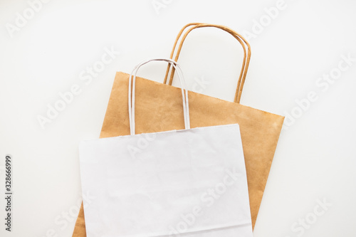 Сraft and white eco-friendly paper bags isolated on white background 