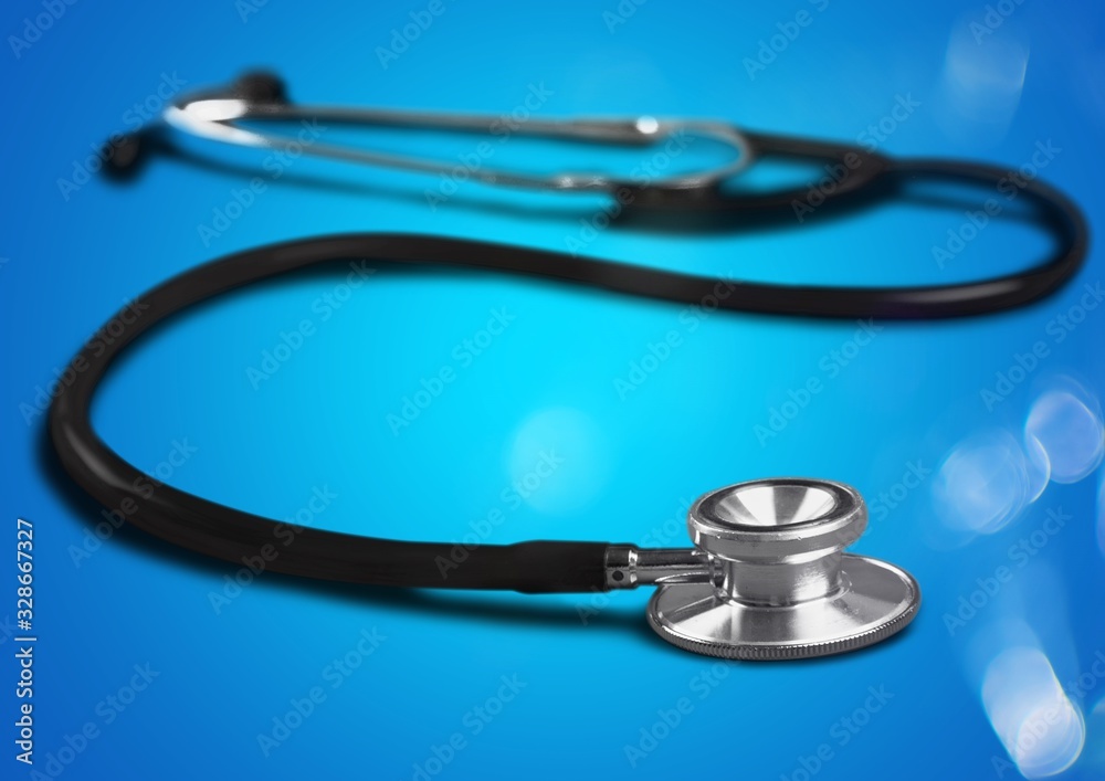 Classic medical stethoscope on the blue background Classic medical stethoscope on the blue background